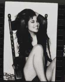 a black and white photo of a woman in a rocking chair with the number 36 on the bottom right