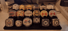 a display of rings including one that says 24 sports