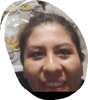 a woman is smiling in front of a table with plates of food