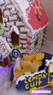 a gingerbread house with a t3 logo on the side of it