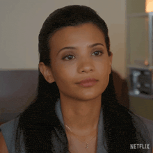a close up of a woman 's face with the netflix logo visible