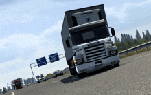 a scania truck is driving down a highway