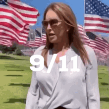 a woman wearing sunglasses stands in front of a field of american flags with the date 9/11 written on the bottom