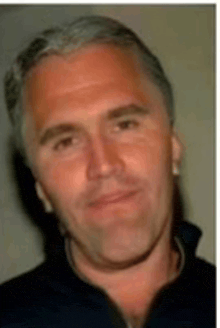 a close up of a man 's face with a blue shirt on