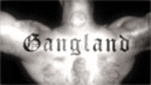 a black and white photo of a person 's hand with the word gangland on it .