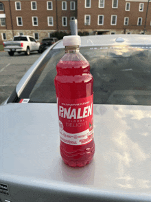 a bottle of finalen liquid delight sits on top of a car