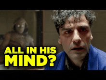 a man with curly hair is standing in front of a mirror with the words `` all in his mind '' written on it .