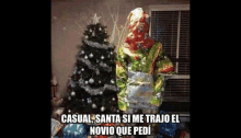 a person wrapped in christmas presents standing next to a christmas tree .