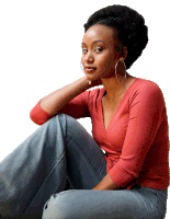 a woman in a red sweater and blue jeans sits on the floor