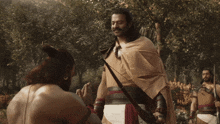a man with a beard holds a spear in his hand
