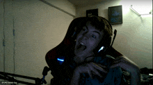 a young man wearing headphones is making a funny face in front of a sign that says " eat peace "