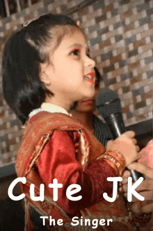 a little girl singing into a microphone with the words cute jk the singer below