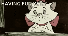 marie from the aristocats is sitting on a wooden table with her arms crossed and a bow on her head .