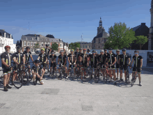 a group of cyclists are posing for a photo with their bikes