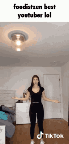 a woman is standing in a room with her arms outstretched in a tiktok video ..