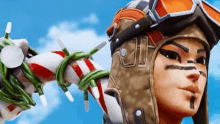 a close up of a person wearing a hat and goggles holding a candy cane .