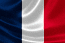 a french flag is waving in the wind with a black background