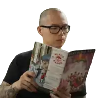 a bald man wearing glasses is reading a book called black beard