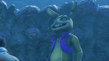 a cartoon rabbit with a purple scarf around its neck is standing in front of a wall of aliens .