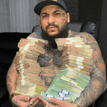 a man with a tattoo on his face is holding stacks of money in his hands