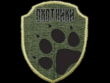 a patch with a paw print and the word omotehm written on it