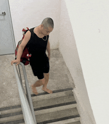 a man with a backpack on his back is walking up the stairs