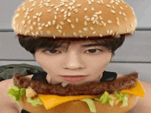 a man with a hamburger on his head