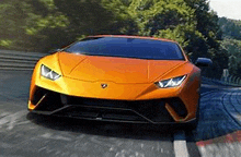 a close up of a lamborghini huracan driving down a race track .