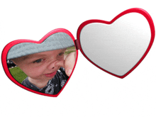 a heart shaped mirror with a picture of a child on it