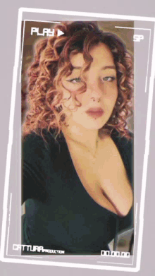 a picture of a woman with curly hair is being played on a play button