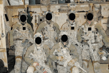 a group of soldiers posing for a photo with their faces covered