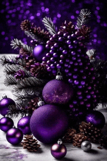 purple christmas decorations with pine cones and berries