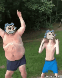 a man and a boy are dancing in the grass with cartoon faces on them .