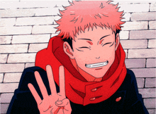 a man with red hair and a red scarf is smiling and giving the peace sign