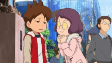 a boy and a girl are standing next to each other in front of a building in a city .