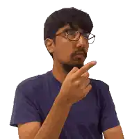 a man with glasses and a beard is pointing his finger at something