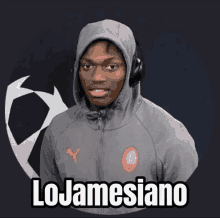 a man wearing a hoodie and headphones has the name lojamesiano on his chest