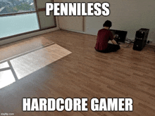 a man sits on the floor in front of a computer with the words penniless hardcore gamer written below him