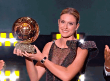 a woman in a dress holds a trophy that says ' winner of the women 's world cup ' on it