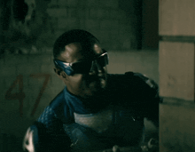 a man in a superhero costume with the number 47 on the wall