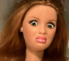 a close up of a doll making a face