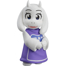 a figurine of a sheep wearing a purple dress