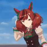 a girl with red hair and green and red ears is wearing a black vest