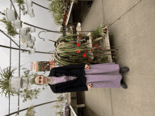 a woman in a purple dress stands in front of a sign that says dragon wing