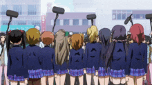 a group of girls are standing in front of a building with a sign that says cafe