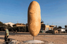 a statue of a potato with a face on it