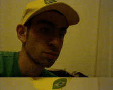 a man wearing a yellow hat with a green eye