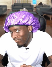 a man wearing a purple hat and white shirt