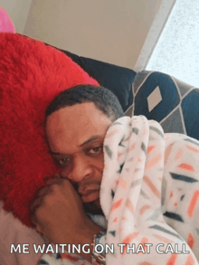 a man wrapped in a blanket with the words me waiting on that call on the bottom