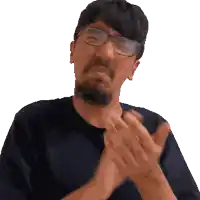 a man wearing glasses is clapping his hands